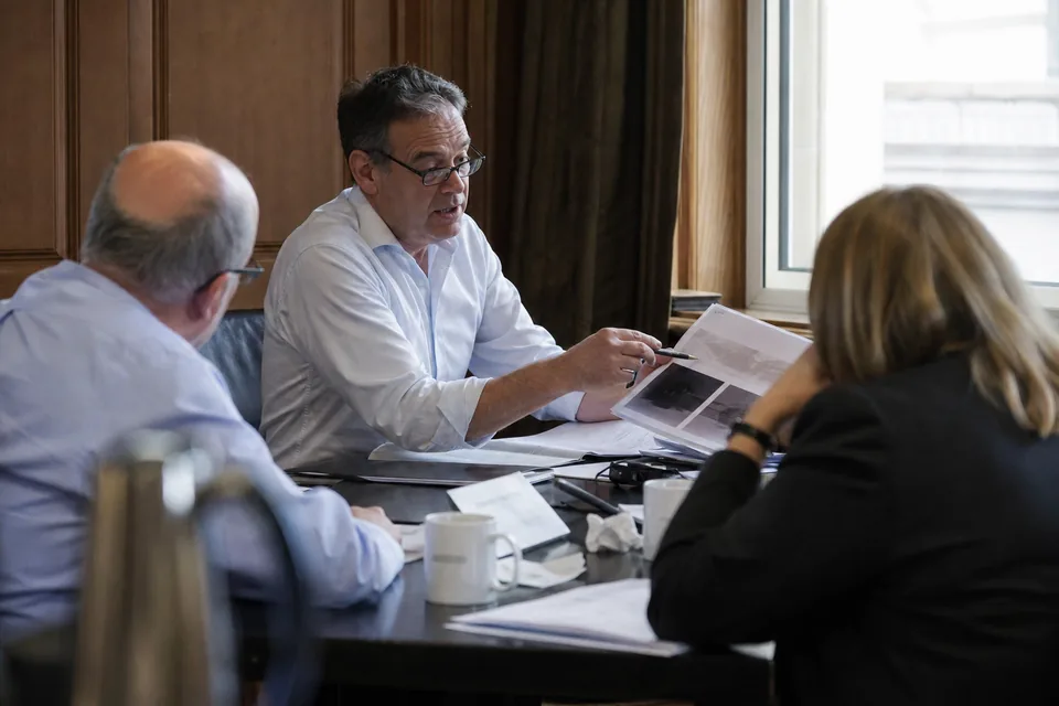 Fund partner preparing a quarterly letter to limited partners in a quiet office