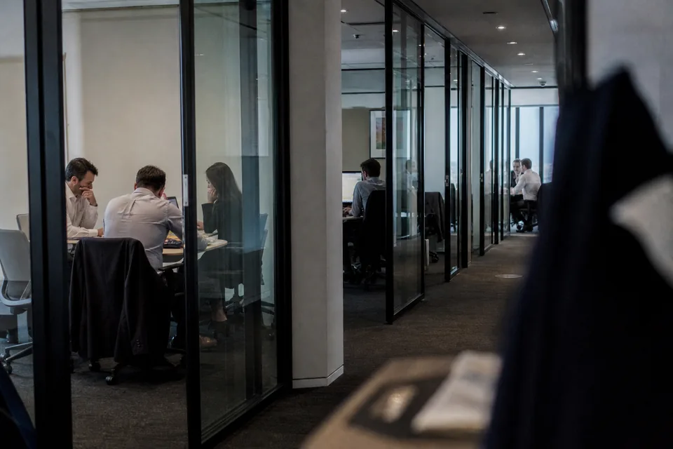 CFO and head of investor relations reviewing an investor brief at a meeting table